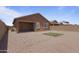 Gravel backyard featuring covered patio, pavers, artificial turf and block wall at 3847 S 63Rd Dr, Phoenix, AZ 85043