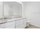 Bathroom vanity showcasing granite countertops, double sinks, and updated fixtures at 3847 S 63Rd Dr, Phoenix, AZ 85043