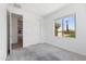 Carpeted bedroom with a window allowing natural light and a sliding-door closet at 3847 S 63Rd Dr, Phoenix, AZ 85043