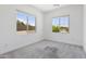 Bright bedroom with two windows allowing natural light and neutral carpet at 3847 S 63Rd Dr, Phoenix, AZ 85043