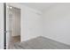 Neutral bedroom featuring a sliding closet door, gray carpet, and white walls at 3847 S 63Rd Dr, Phoenix, AZ 85043