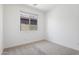 Neutral bedroom features a window offering natural light and neutral carpeting at 3847 S 63Rd Dr, Phoenix, AZ 85043