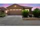 Inviting single-story home with a desert landscape, a two-car garage, and stone facade accents at 3847 S 63Rd Dr, Phoenix, AZ 85043