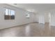 Modern living space featuring neutral tones, large windows, and tiled flooring at 3847 S 63Rd Dr, Phoenix, AZ 85043