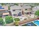 Aerial view of a backyard with a pool, patio, trampoline, swing set, and lush green grass at 4328 W Judson Dr, New River, AZ 85087