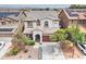 Aerial view of a two-story home featuring a tile roof, archway, and colorful front yard landscaping at 4328 W Judson Dr, New River, AZ 85087