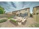 Large backyard featuring gravel, patio, trampoline, dining area, fire pit, and swing set at 4328 W Judson Dr, New River, AZ 85087