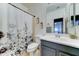 Bathroom featuring a floral shower curtain, updated vanity, and neutral tile floors at 4328 W Judson Dr, New River, AZ 85087