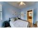 Blue bedroom featuring a ceiling fan, neutral carpet, and an attached bathroom at 4328 W Judson Dr, New River, AZ 85087