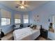 Blue bedroom featuring a ceiling fan, neutral carpet, and a desk area at 4328 W Judson Dr, New River, AZ 85087