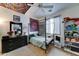 Eclectic bedroom with decoratively painted ceiling, tapestry, dresser, and four-poster bed at 4328 W Judson Dr, New River, AZ 85087