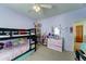 This bedroom offers a bunk bed, ceiling fan, shelves with toys, and a vanity with mirror at 4328 W Judson Dr, New River, AZ 85087