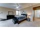 This bedroom features neutral walls, a ceiling fan, a dresser with a mirror, and a queen bed at 4328 W Judson Dr, New River, AZ 85087