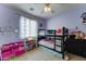Bedroom featuring a bunk bed, shelving, and a ceiling fan at 4328 W Judson Dr, New River, AZ 85087