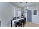 Chic dining area with modern lighting fixture, sleek table, and window view at 4328 W Judson Dr, New River, AZ 85087