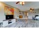 Bright living room showcasing hardwood floors, ceiling fans, and neutral wall paint at 4328 W Judson Dr, New River, AZ 85087