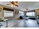 Bright living room featuring hardwood floors, ceiling fans, and a gray couch at 4328 W Judson Dr, New River, AZ 85087