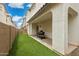 Inviting backyard with artificial grass and covered patio featuring a barbeque for outdoor entertaining at 4353 E Erie St, Gilbert, AZ 85295