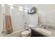 Cozy bathroom featuring a shower over tub, granite counter on the vanity, and a cabinet at 4353 E Erie St, Gilbert, AZ 85295