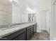 Bathroom featuring double granite vanity, stylish mirrors, and access to the shower and commode at 4353 E Erie St, Gilbert, AZ 85295