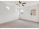 Bright bedroom with neutral carpet and paint, a modern ceiling fan and three sunny windows at 4353 E Erie St, Gilbert, AZ 85295