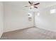 Bright bedroom featuring neutral carpet and paint, a modern ceiling fan, and three sunny windows at 4353 E Erie St, Gilbert, AZ 85295