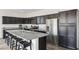 Kitchen with stainless steel appliances, dark cabinets, and granite countertops for a modern and stylish look at 4353 E Erie St, Gilbert, AZ 85295