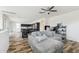 Open-concept living area with wood floors, a gray sectional, and a view into the kitchen at 4353 E Erie St, Gilbert, AZ 85295