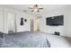 Main bedroom with carpet, ceiling fan, and media setup, plus access to the ensuite bathroom at 4353 E Erie St, Gilbert, AZ 85295