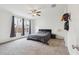 Bright primary bedroom with a ceiling fan, carpet floors, and large windows at 4353 E Erie St, Gilbert, AZ 85295