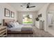 Bright bedroom with ceiling fan, neutral tones, and sliding door to backyard at 45 S Rita Ln, Chandler, AZ 85226