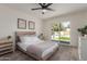 Bright bedroom with ceiling fan, neutral tones, and sliding door to backyard at 45 S Rita Ln, Chandler, AZ 85226