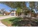 Beautiful single-story home with a well-maintained lawn, desert landscaping, and trees at 45 S Rita Ln, Chandler, AZ 85226