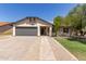 Charming single-story home featuring a gray garage door and manicured front yard at 45 S Rita Ln, Chandler, AZ 85226