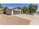 Side view of a single-story home with a gray garage door and desert landscaping at 45 S Rita Ln, Chandler, AZ 85226