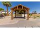 Wooden gazebo with a tiled platform offers a stylish outdoor living space at 45 S Rita Ln, Chandler, AZ 85226