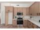 Modern kitchen with wooden cabinets, stainless steel appliances, and white countertops at 45 S Rita Ln, Chandler, AZ 85226
