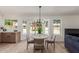 A dining area with modern chandelier and kitchen in the background at 45 S Rita Ln, Chandler, AZ 85226
