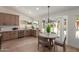 Bright kitchen featuring wooden cabinets, stainless steel appliances, and a dining area at 45 S Rita Ln, Chandler, AZ 85226