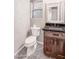 Powder room featuring dark cabinets, granite countertops, and neutral walls at 5520 E Desert Forest Trl, Cave Creek, AZ 85331