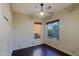 Bedroom with wooden floor, ceiling fan and three windows at 5520 E Desert Forest Trl, Cave Creek, AZ 85331