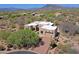 Stunning aerial view of the custom home featuring a private driveway and desert landscaping in a serene environment at 5520 E Desert Forest Trl, Cave Creek, AZ 85331