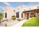 Exterior elevation showcasing a beige stucco home with desert landscaping and a welcoming walkway at 5520 E Desert Forest Trl, Cave Creek, AZ 85331