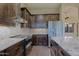 Modern kitchen featuring stainless steel appliances, stone backsplash, and custom cabinetry at 5520 E Desert Forest Trl, Cave Creek, AZ 85331