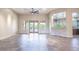 Bright living room with tile flooring, ceiling fan, and double doors leading to the pool at 5520 E Desert Forest Trl, Cave Creek, AZ 85331