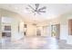 Spacious living room with tiled floors and a large ceiling fan and access to a modern kitchen at 5520 E Desert Forest Trl, Cave Creek, AZ 85331