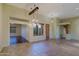 Large living room with hanging light fixtures and access to other rooms at 5520 E Desert Forest Trl, Cave Creek, AZ 85331