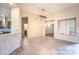 Open-concept living room featuring tile flooring and bar top, connecting seamlessly to the kitchen at 5520 E Desert Forest Trl, Cave Creek, AZ 85331