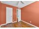 Bedroom with laminate floors, a ceiling fan, and an adjoining closet and door at 600 S Dobson Rd # 178, Mesa, AZ 85202