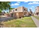 Well-maintained two-story townhouse with block wall and lush green lawn at 600 S Dobson Rd # 178, Mesa, AZ 85202